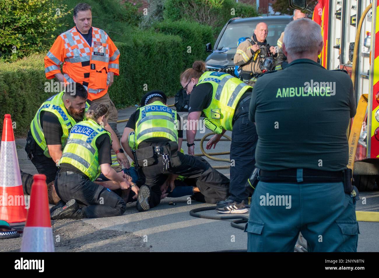 Trowbridge Wiltshire UK Aug 25 2022. Officers from the Wiltshire police service arresting a combative individual at an ongoing incident while members Stock Photo