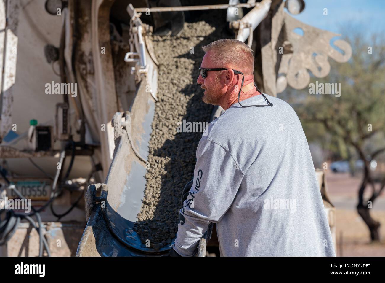 Ralph Gunarson, 355th Civil Engineer Squadron heavy equipment specialist, pours concrete at Davis-Monthan Air Force Base, Ariz., Jan. 17, 2023. Gunarson took part in the project to create a drill pad for the DM honor guard team. Stock Photo