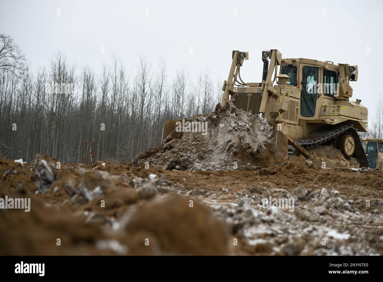 Soldiers from the 1432nd Engineer Company, Michigan National Guard use heavy equipment to move dirt during Northern Strike 23-1, Jan. 27, 2023, at Camp Grayling, Mich. Northern Strike’s winter iteration offers units a chance to train in a joint, all-domain, cold-weather environment. Stock Photo