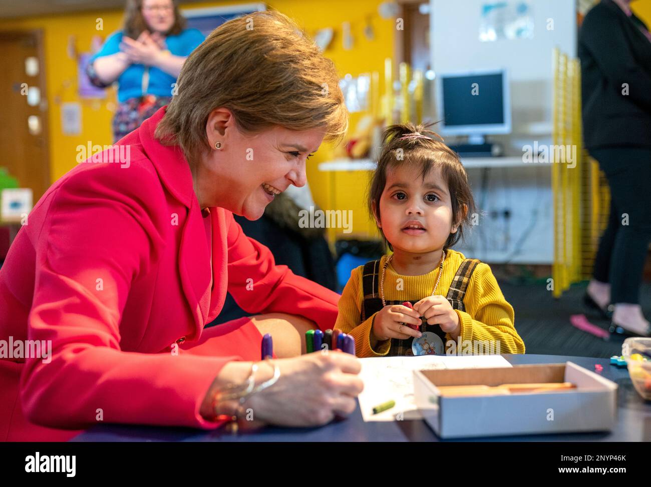 First Minister Nicola Sturgeon with Ayat Hamid, aged 3, during a visit to Wester Hailes Library, Edinburgh, to join in with a Bookbug session to celebrate World Book Day with children and their families. Picture date: Thursday March 2, 2023. Stock Photo