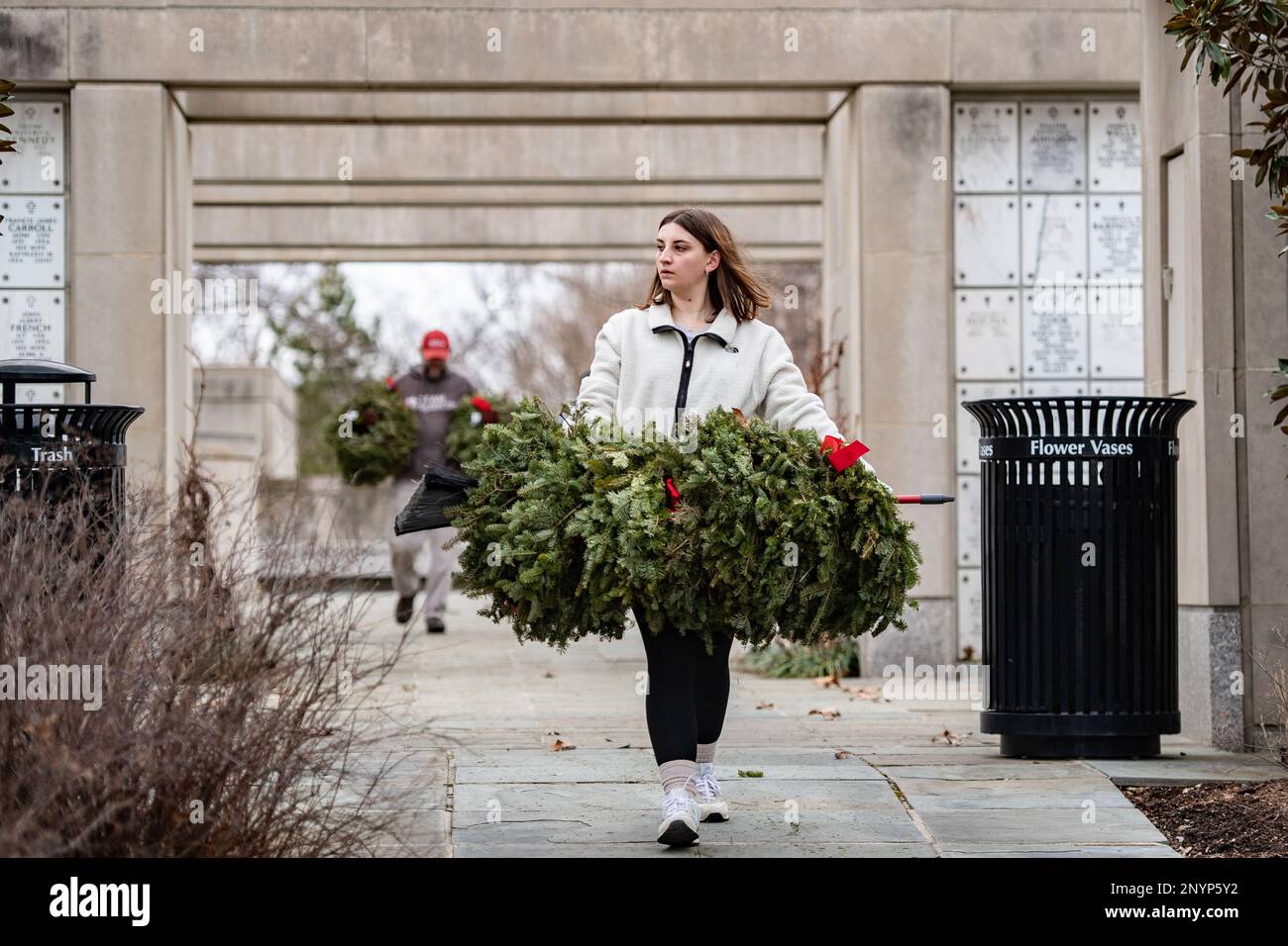 Volunteers participate in the Wreaths Across America’s clean-up day, commonly known as Wreaths Out, in Columbarium Court 3 of Arlington National Cemetery, Arlington, Va., Jan. 21, 2023. This year, over 3,000 volunteers participated and removed the 257,000 wreaths originally placed at ANC on Dec. 17, 2022. Stock Photo