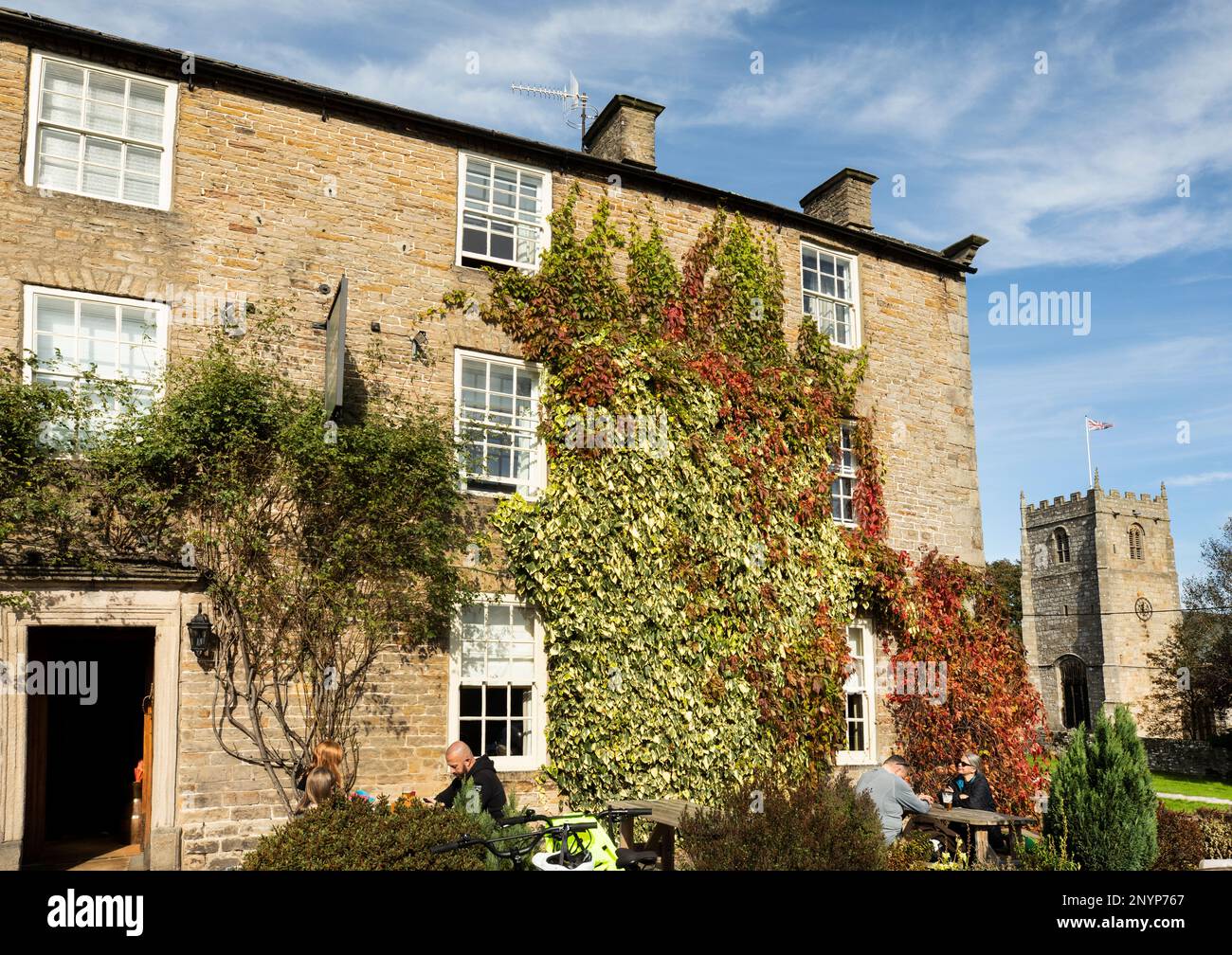 People sit outside The Rose and Crown Hotel in Romaldkirk Village on a