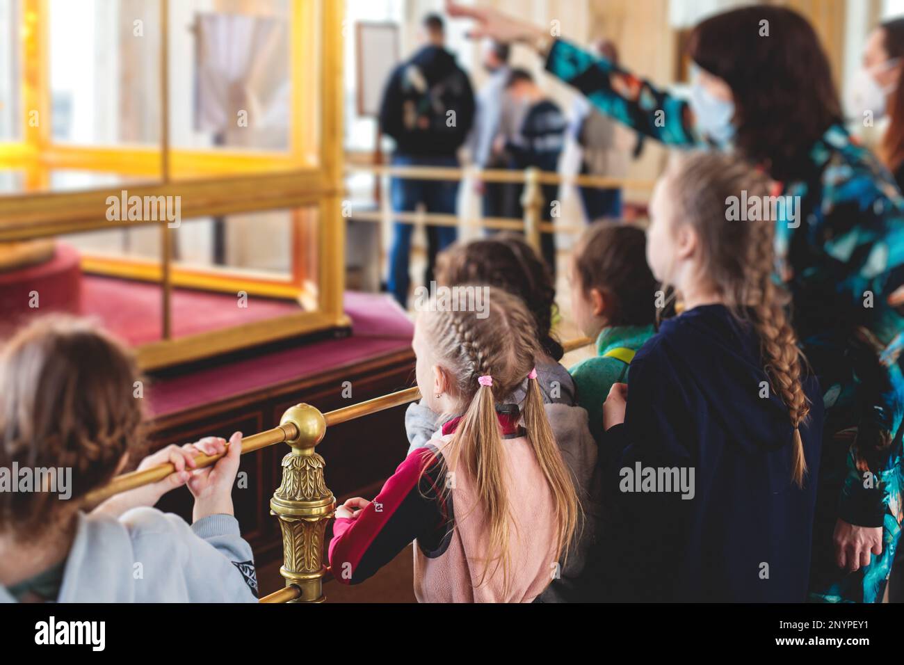 Group of kids children on excursion visit gallery museum with tour