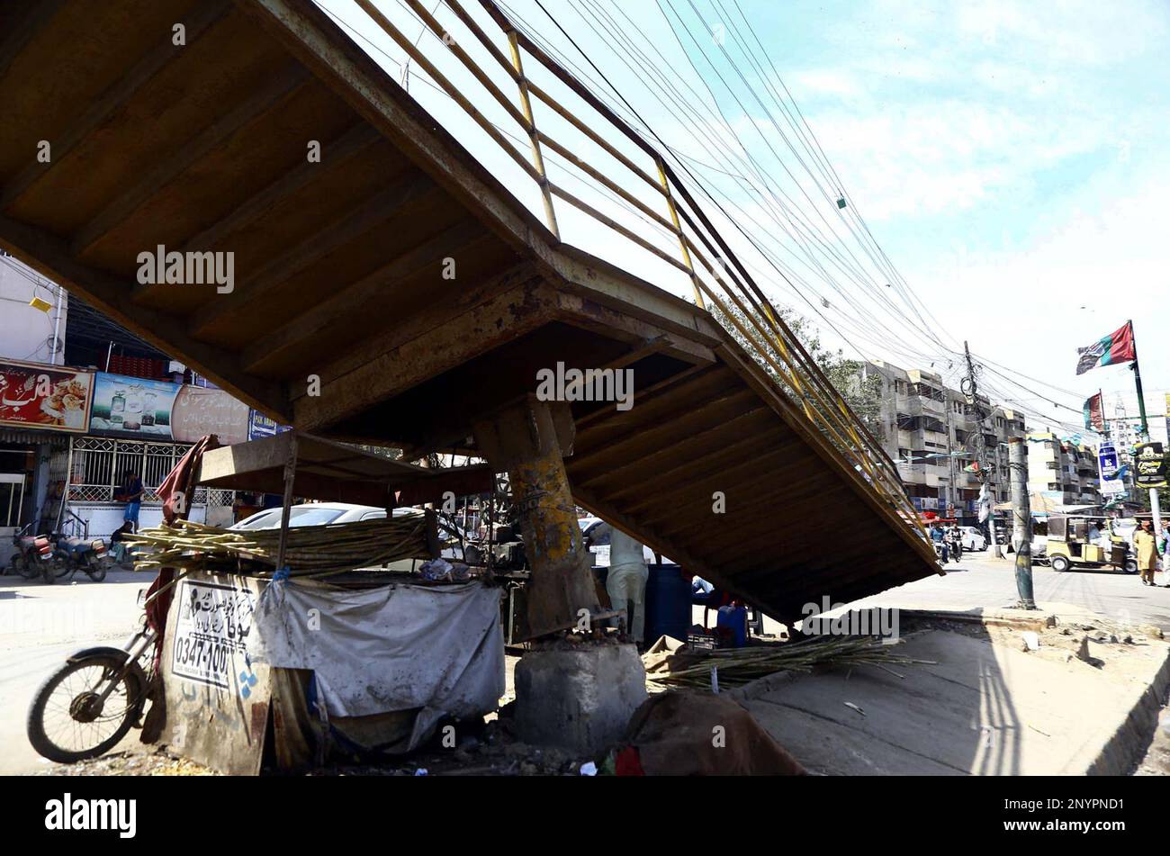 Commuters Pass Through The Damaged Pedestrian Bridge That May Cause Any