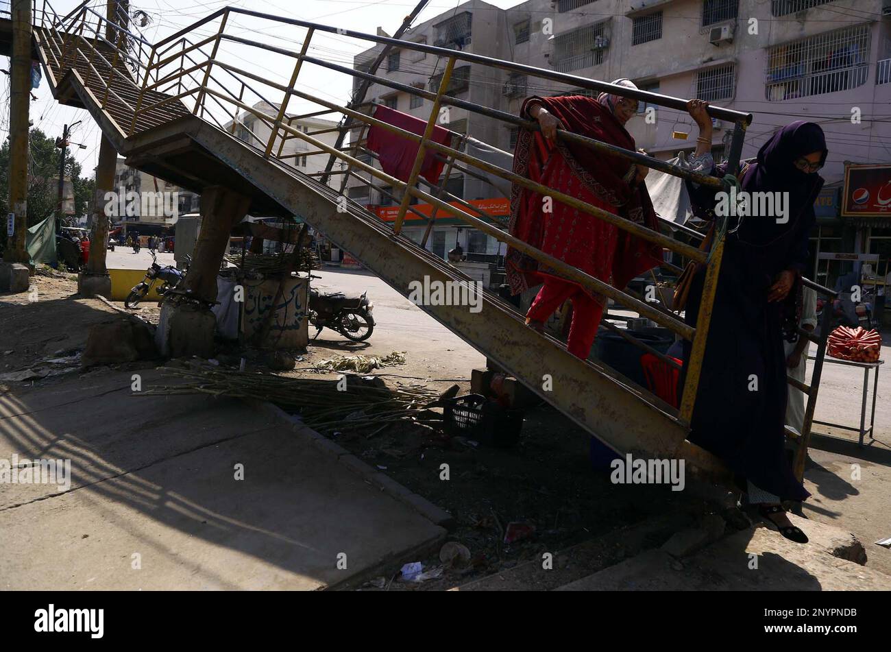 Commuters Pass Through The Damaged Pedestrian Bridge That May Cause Any