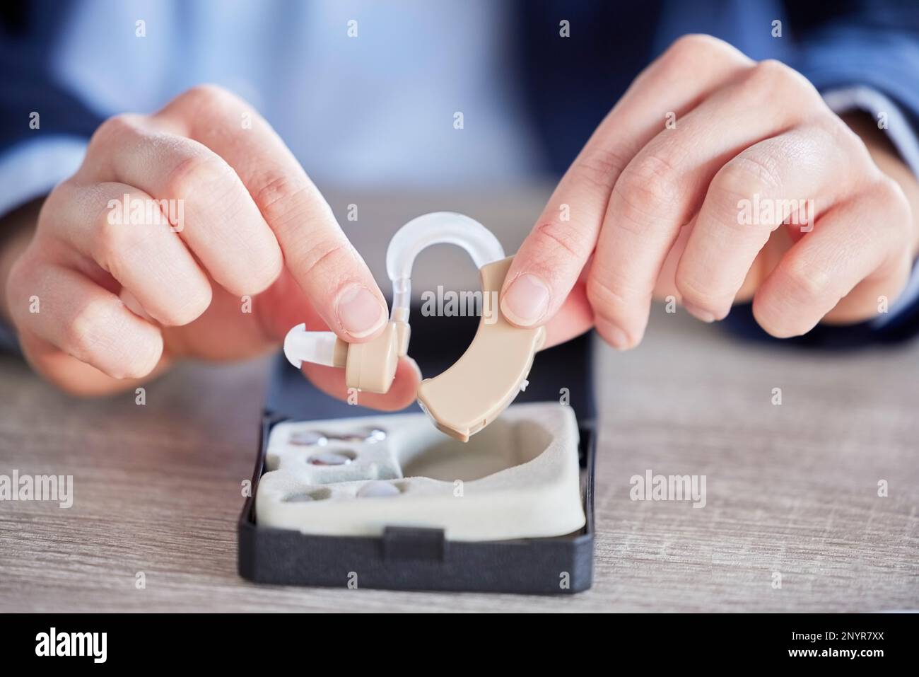 Hearing aid, disability help tool and hands with hospital, wellness and