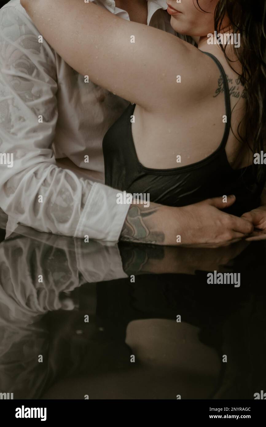 Couple with Tattoos in Water Stock Photo