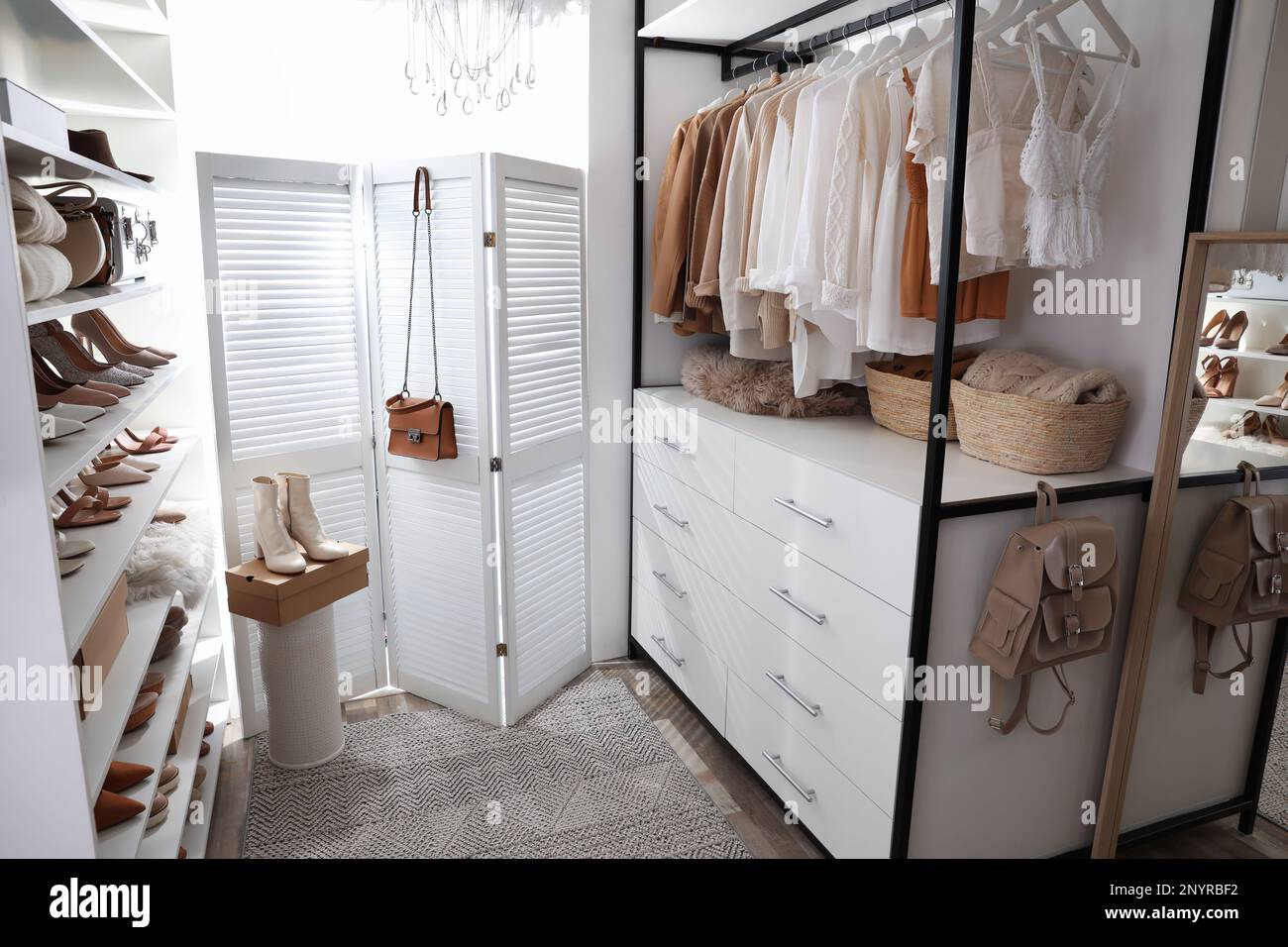 Dressing room interior with clothes rack and collection of stylish ...