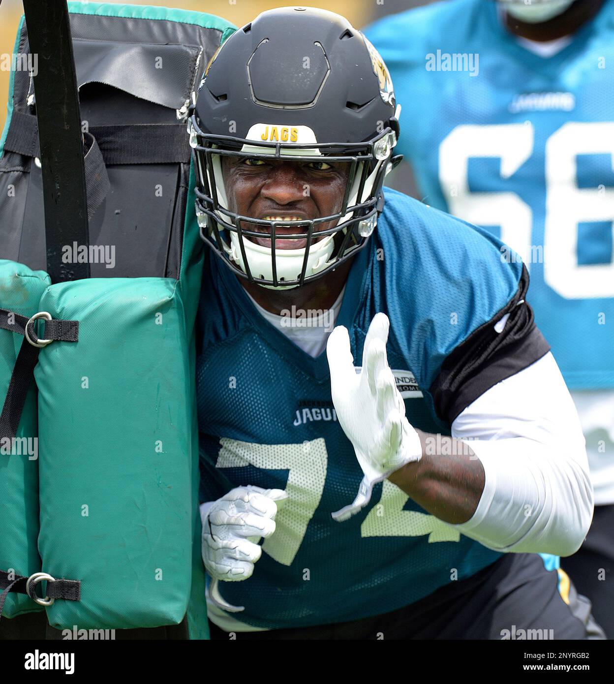 Jacksonville Jaguars offensive lineman Cam Robinson hits a sled during