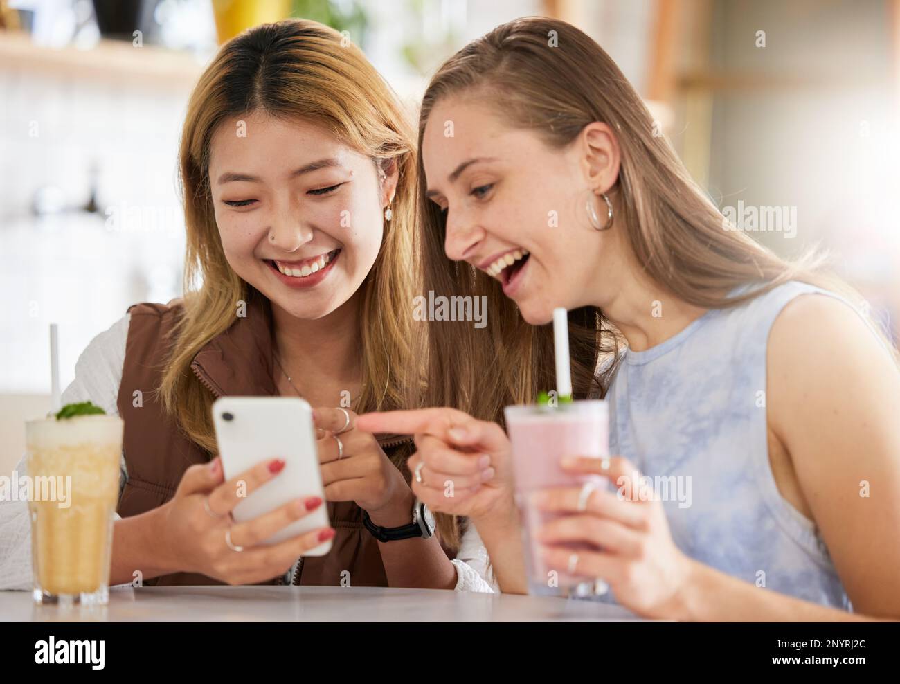 Funny, phone or friends on social media in cafe with happy smile on holiday vacation or weekend. Fake news, web or gen z women reading crazy gossip Stock Photo
