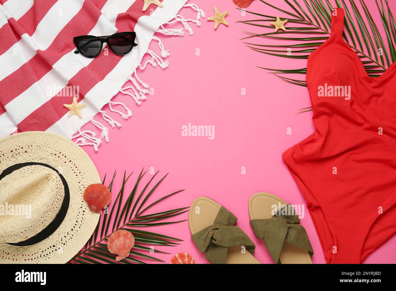 Frame made with different beach objects on pink background, flat lay. Space for text Stock Photo
