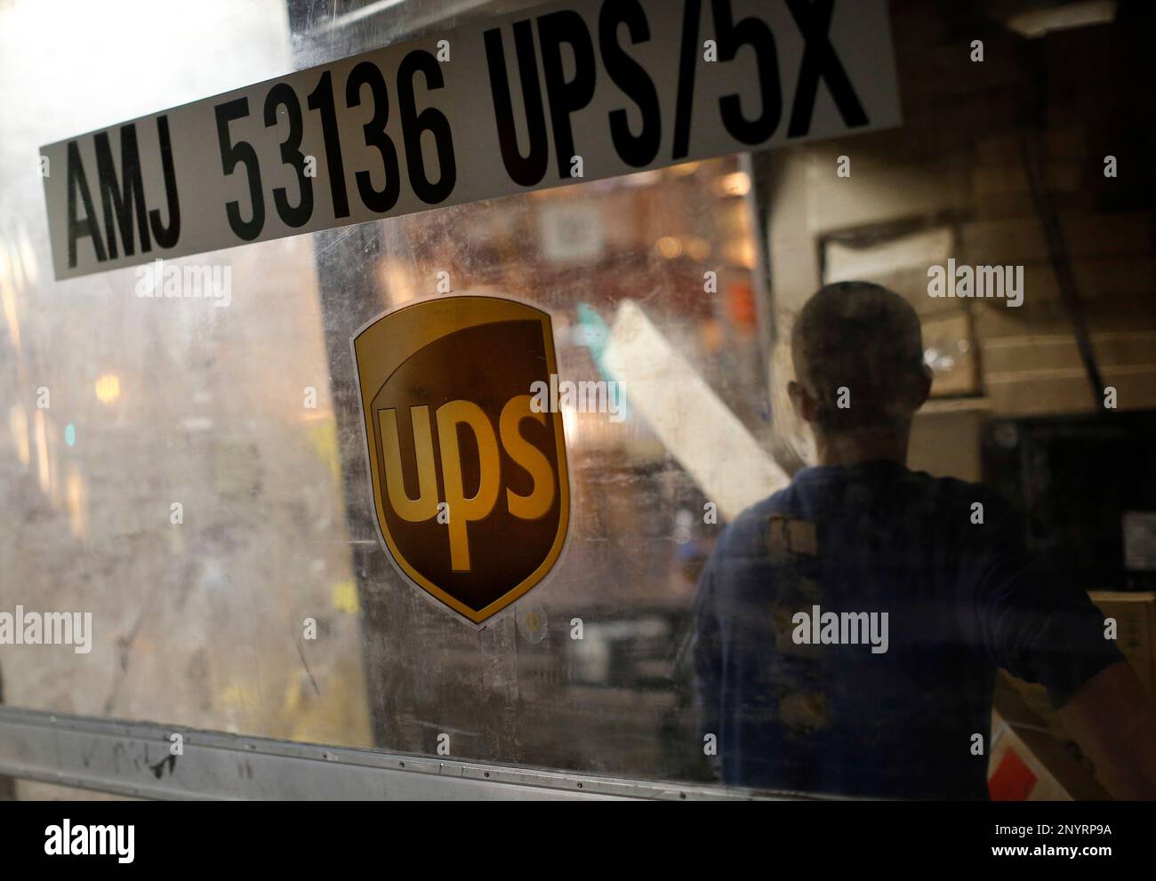 In this Nov. 20, 2015, picture, UPS employee Justin Sims prepares to
