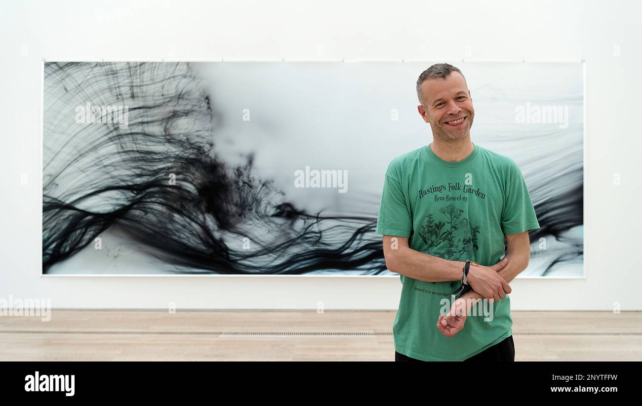 German artist Wolfgang Tillmans poses in front of his artwork 
