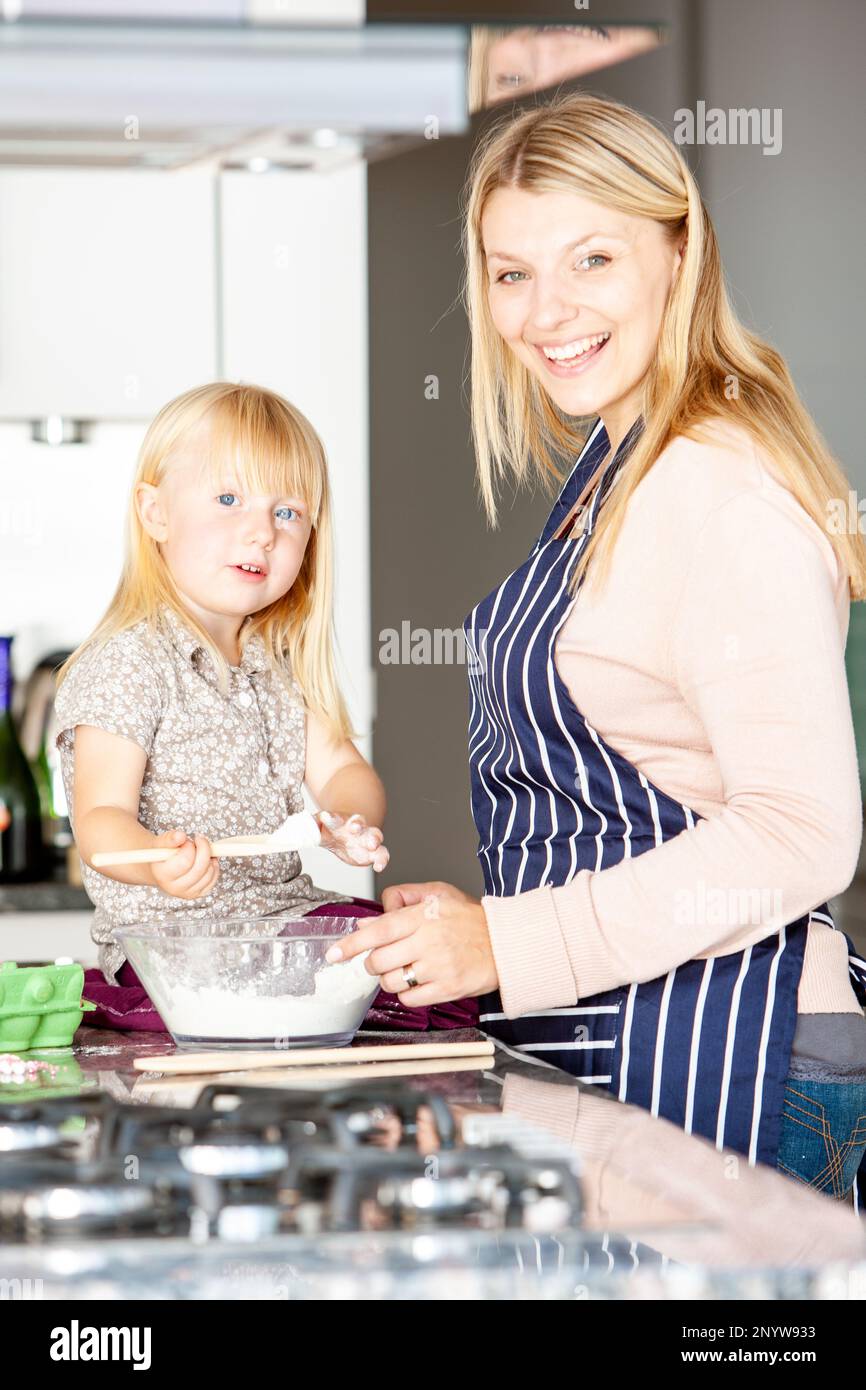 Family Life, Mixing the Cake. A young girl mixing a cake recipe while