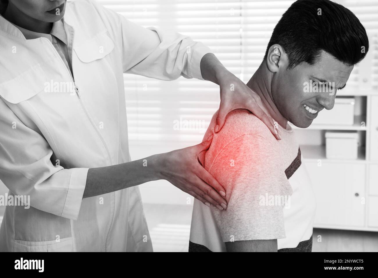 Doctor examining man with shoulder pain in hospital Stock Photo Alamy