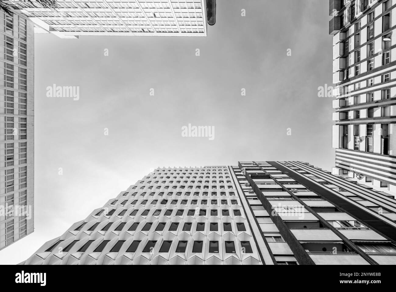 black and white low angle view of office building facades in the city center Stock Photo