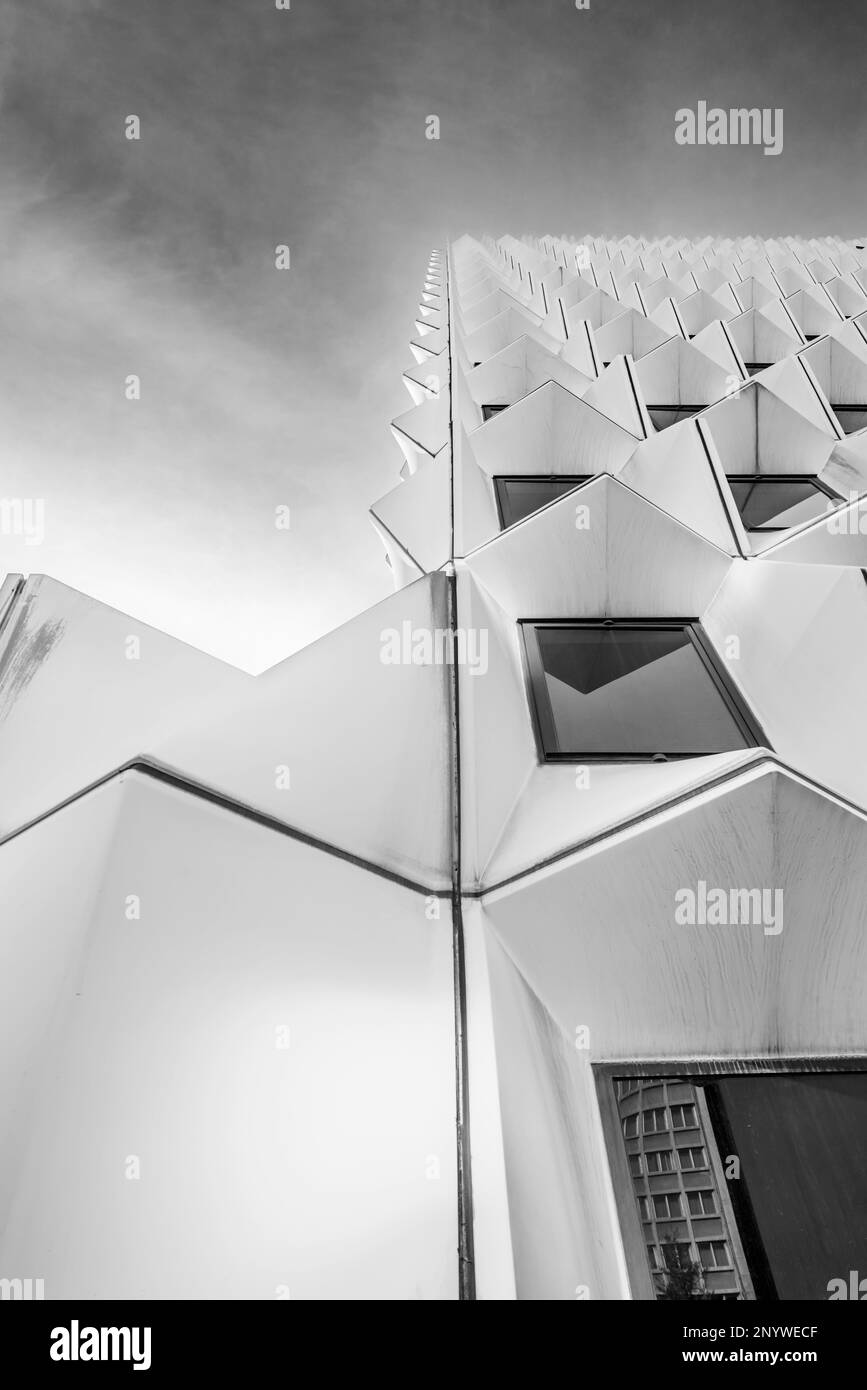 low angle black and white view of office building facades in the city center with characteristic architecture and sky with some clouds Stock Photo