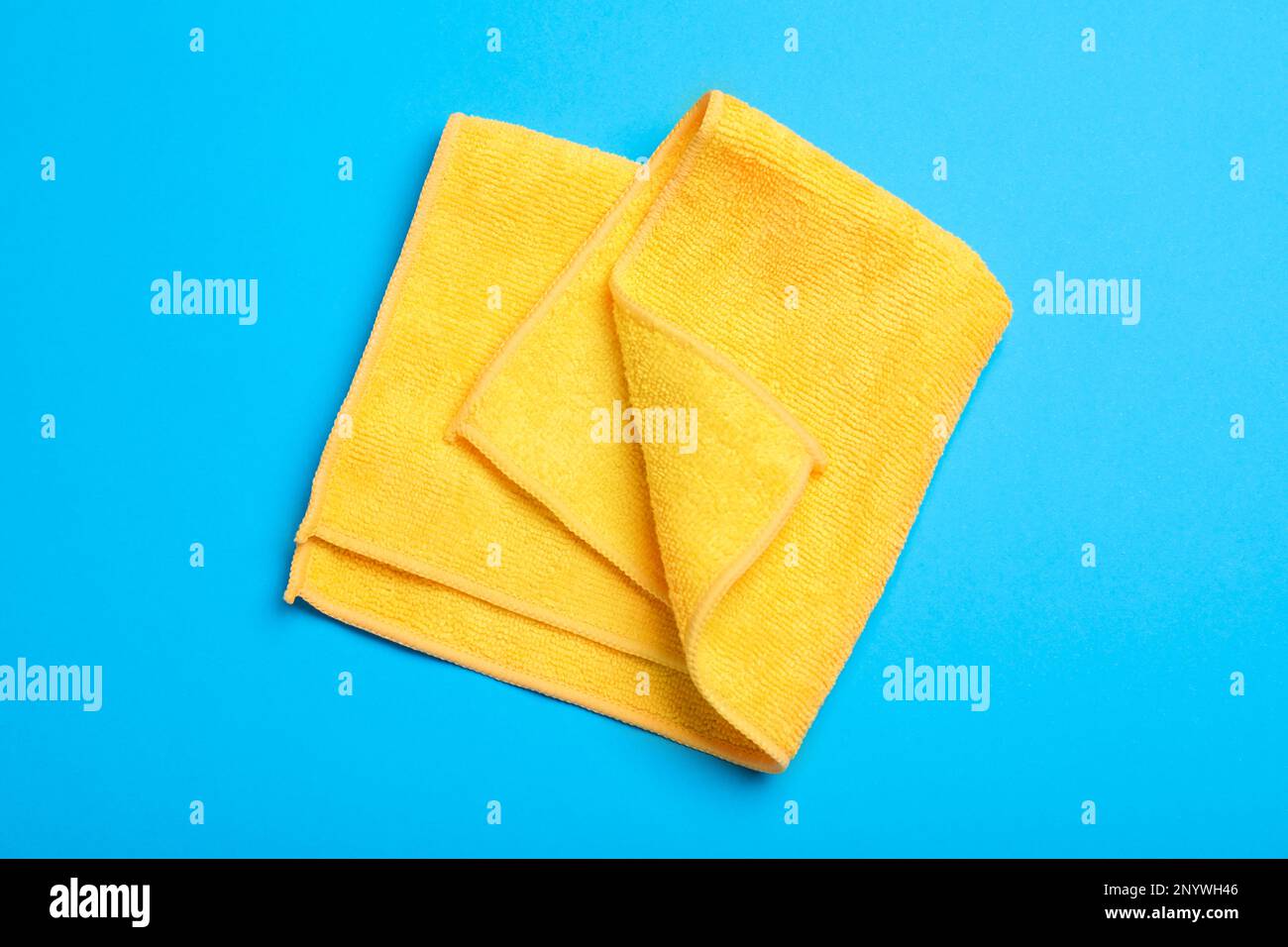Orange microfiber cloth on light blue background, top view Stock Photo