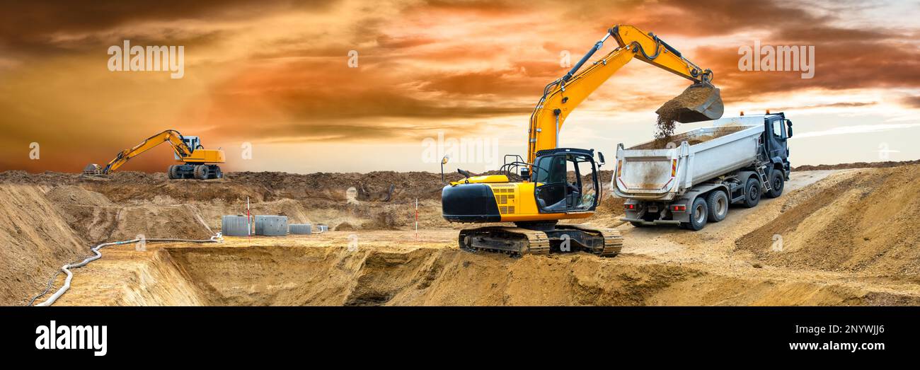excavator ist digging and working at construction site Stock Photo