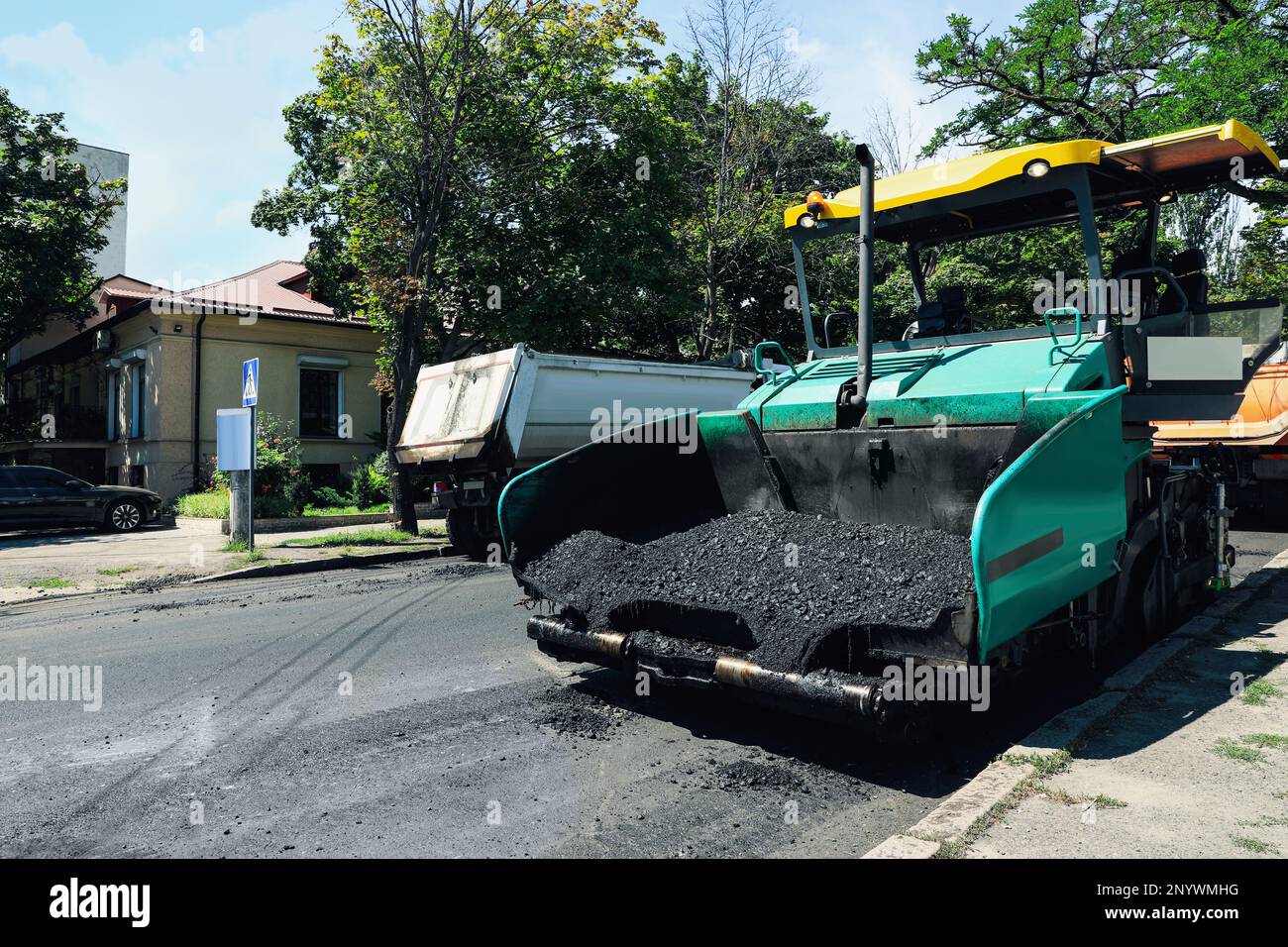 Asphalt paver working on city street. Road repair Stock Photo - Alamy