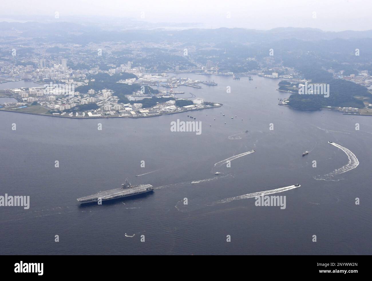 An aerial photo shows an aircraft carrier USS Ronald Reagan (left below