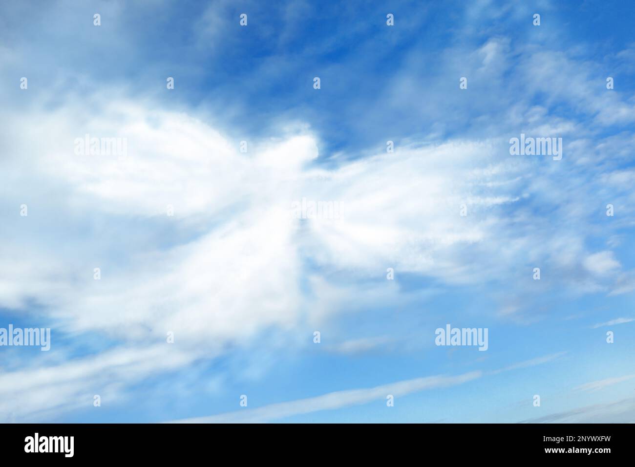 Silhouette of angel made of clouds in blue sky Stock Photo - Alamy