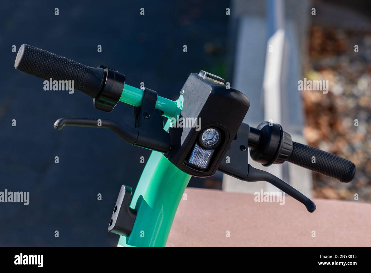 Close up of handlebar of electric scooter with electric lamp and throttle lever for stop and go. Stock Photo