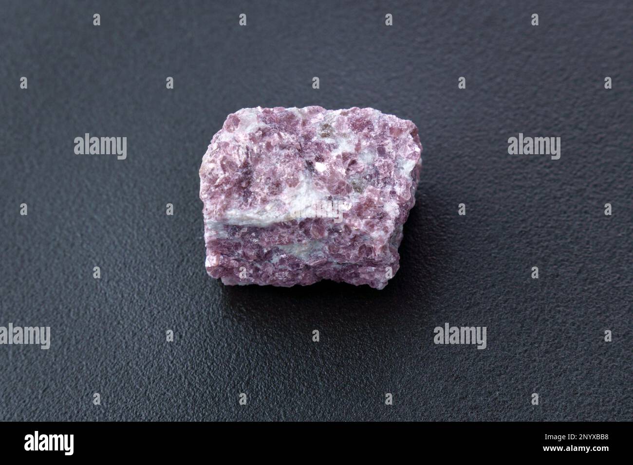 Mineral stone lepidolite. Macro shooting of natural gemstone. The raw mineral. Stock Photo