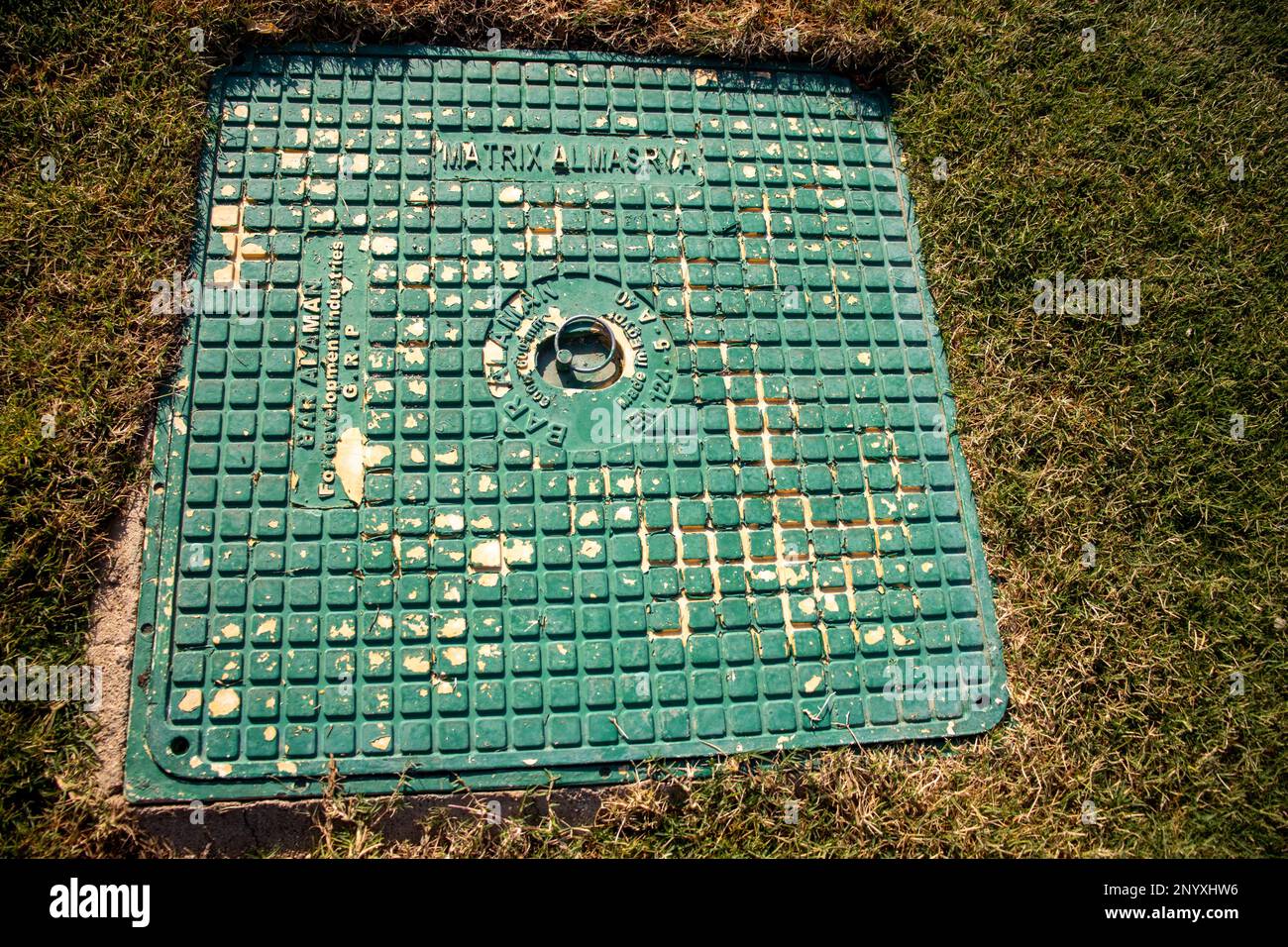 green painted water supply cover in a green lawn Stock Photo