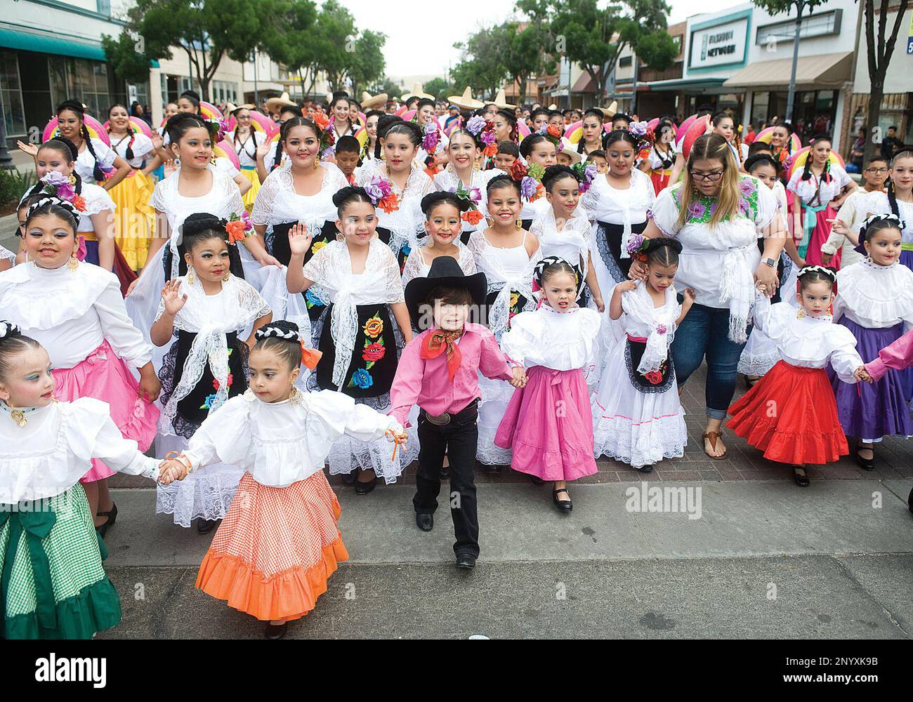 Ballet Folklorico dancers march down Saturday, May 6, 2017 during the