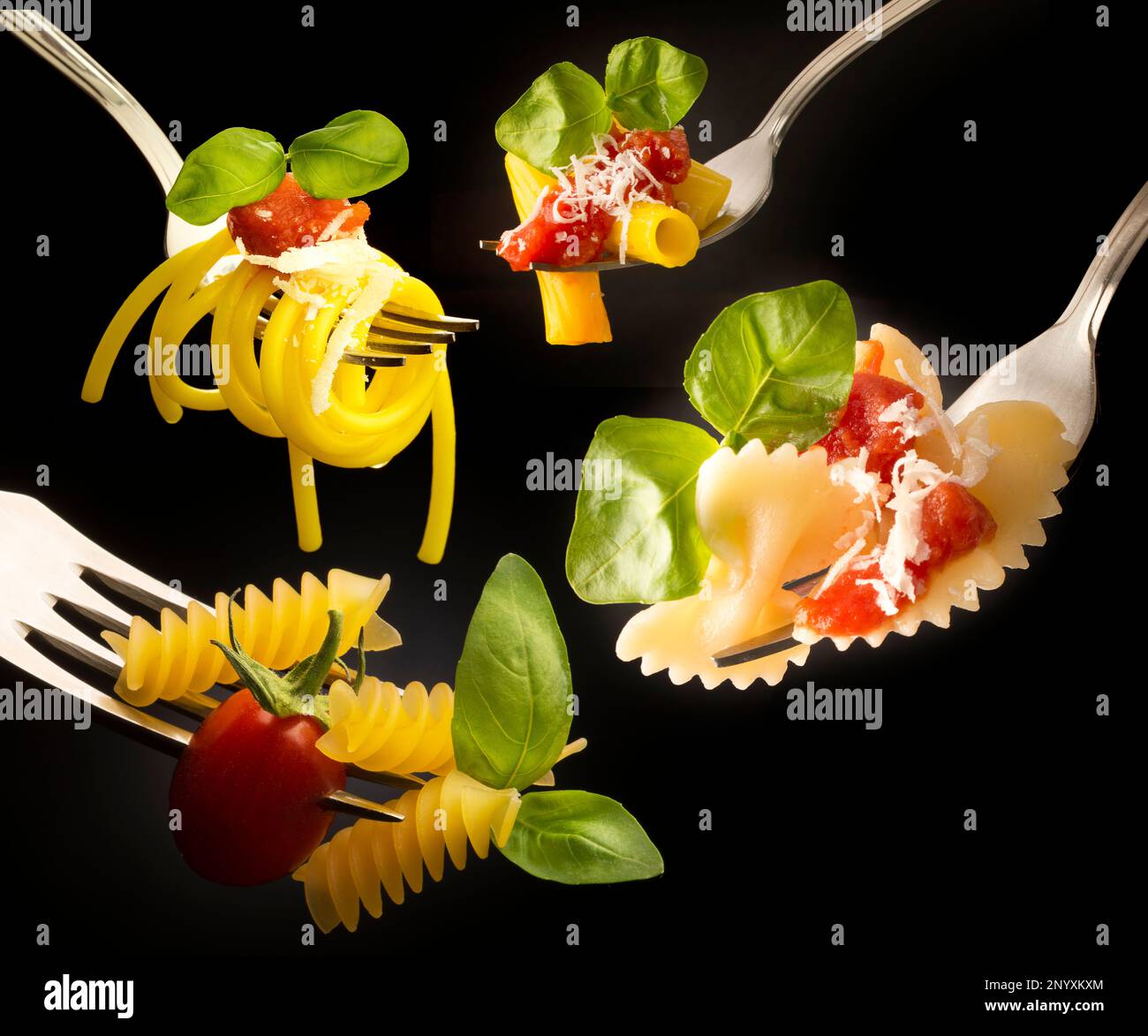 forks with various types of pasta isolated on black background Stock