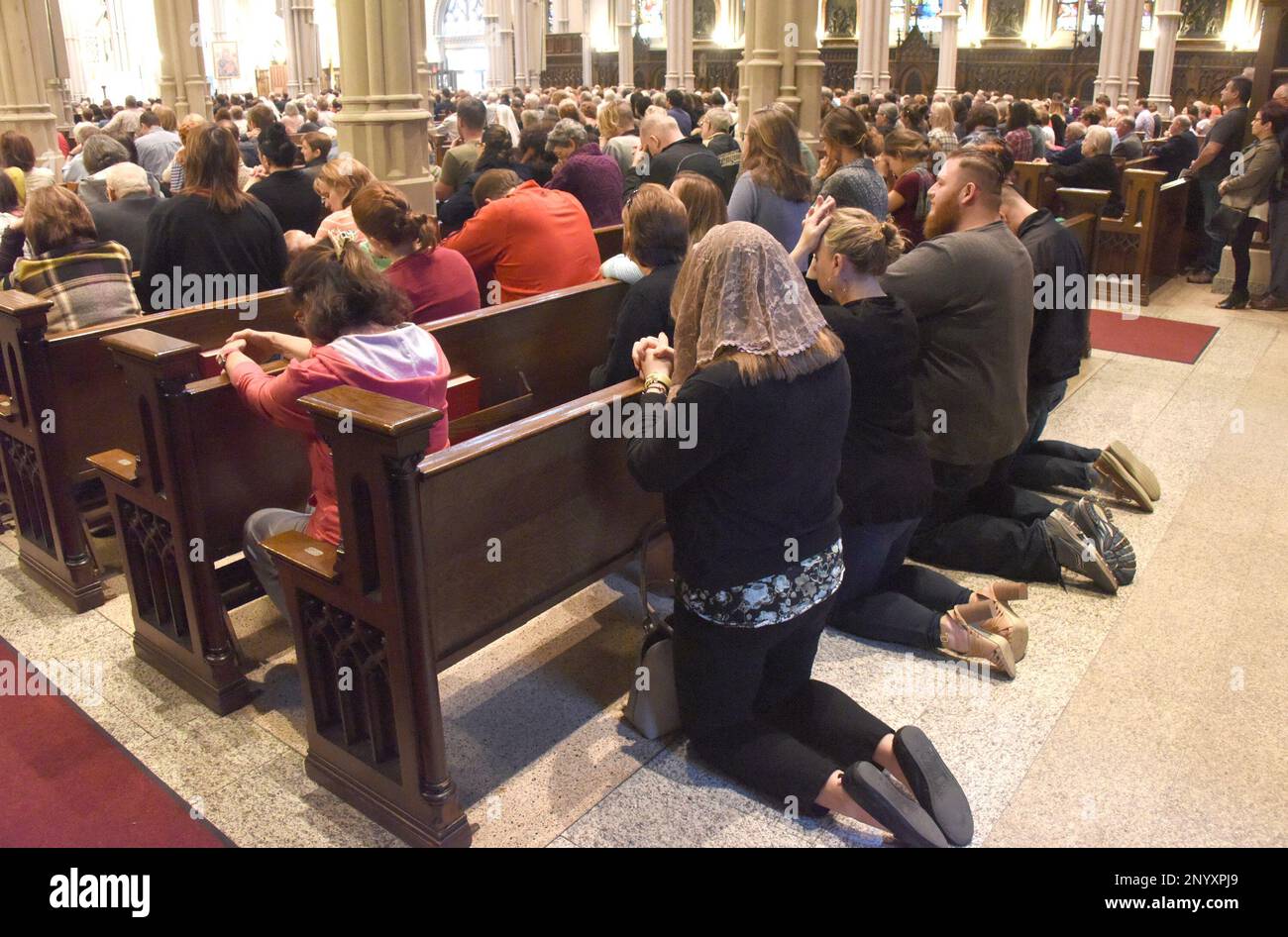 People knelt behind the pews at St. Paul Cathedral as Bishop David ...