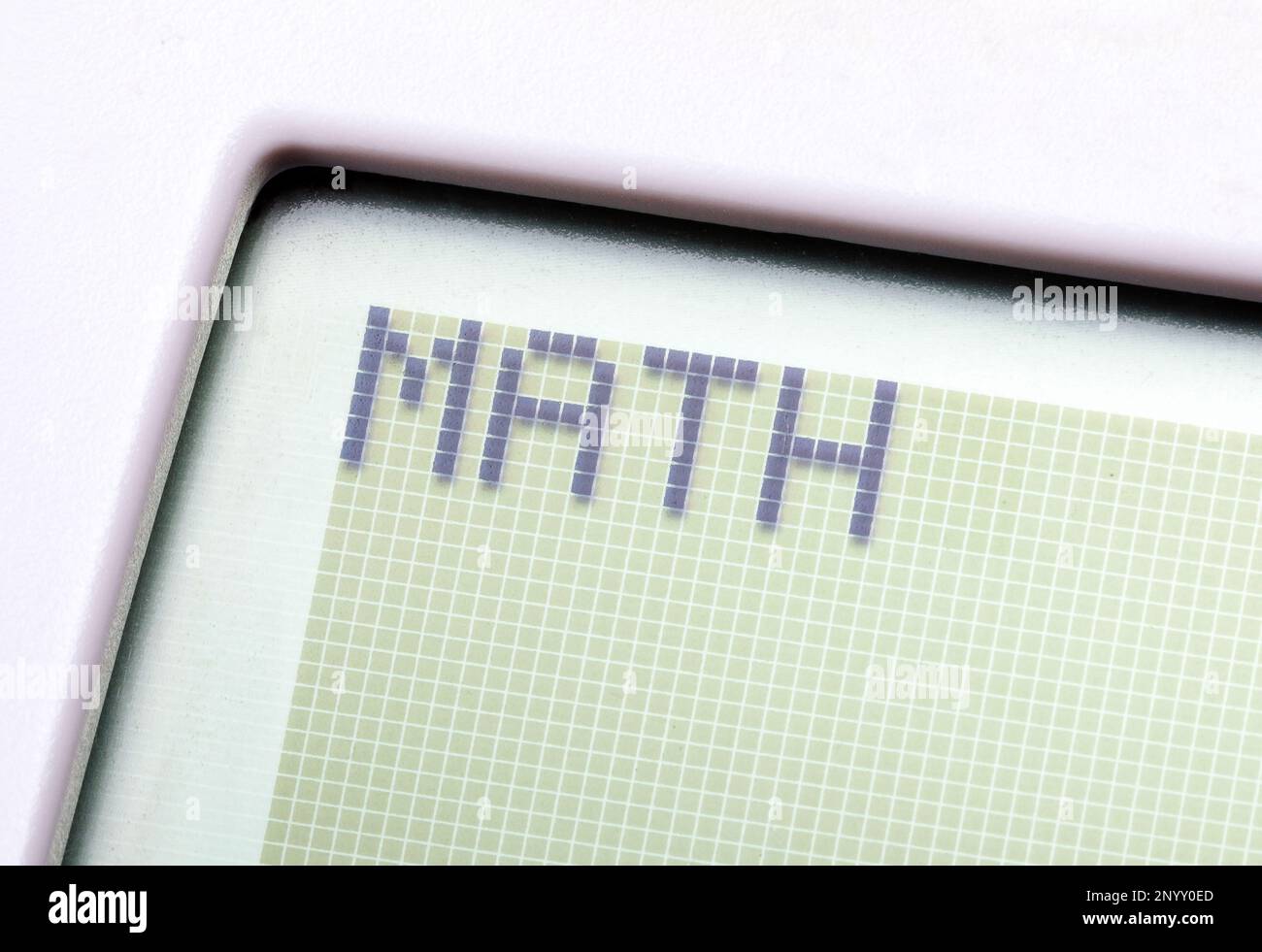 A single word MATH on a graphing calculator digital display, object macro, detail, extreme closeup, nobody. Mathematics, computer science and technolo Stock Photo