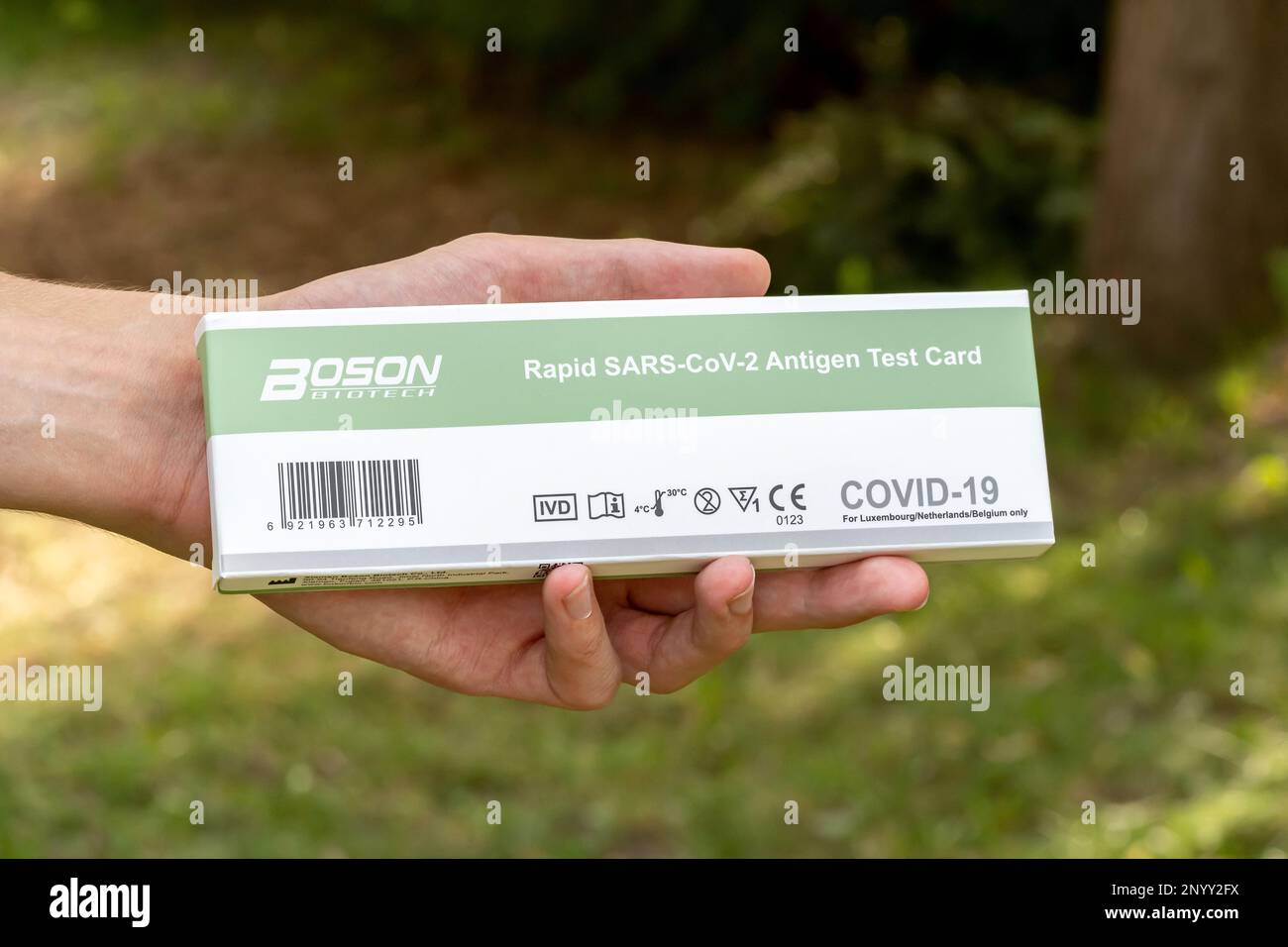 Boson Biotech Rapid SARS-Cov-2 Antigen Test Card COVID-19 coronavirus test package box held in hand full front view object closeup, one person Man, ha Stock Photo