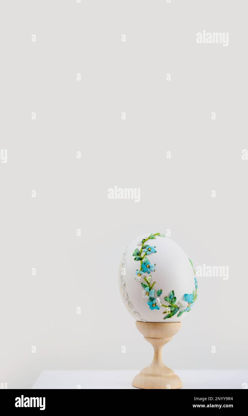 postcard for Instagram phone vertical photo banner place for text Easter egg on stand embroidered with ribbons picture on the egg Easter holiday tasty waiting for guests handmade Stock Photo