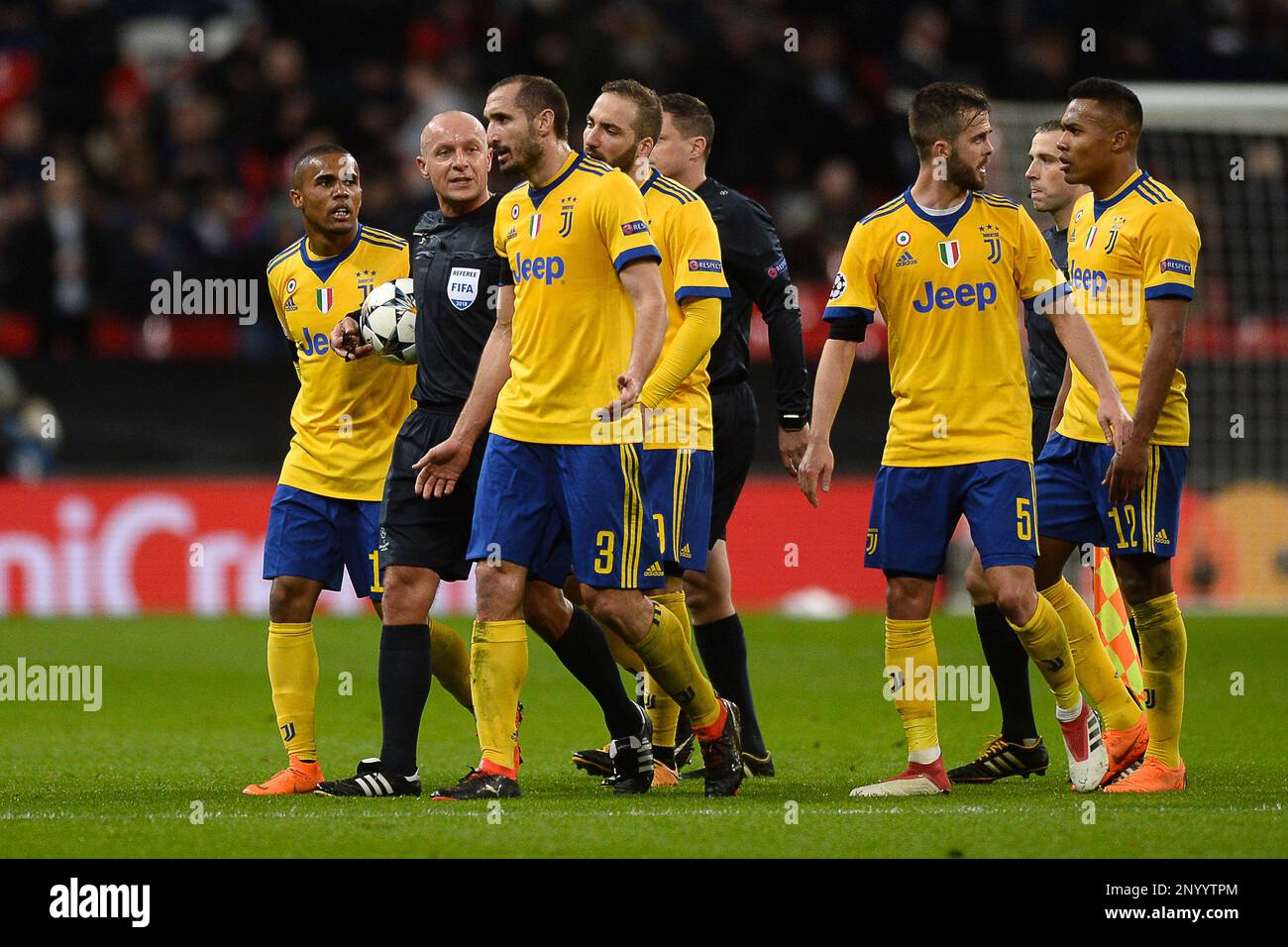 Juventus players surround the Match Referee Szymon Marciniak at half-time as the players leave the pitch - Tottenham Hotspur v Juventus, UEFA Champions League, Round of 16 - Second Leg, Wembley Stadium, London - 7th March 2018. Stock Photo