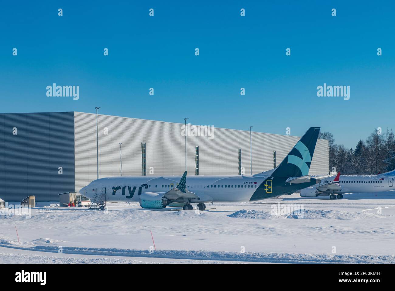 A grounded plane covered in snow belonging to the bankrupt budget airline Flyr Stock Photo