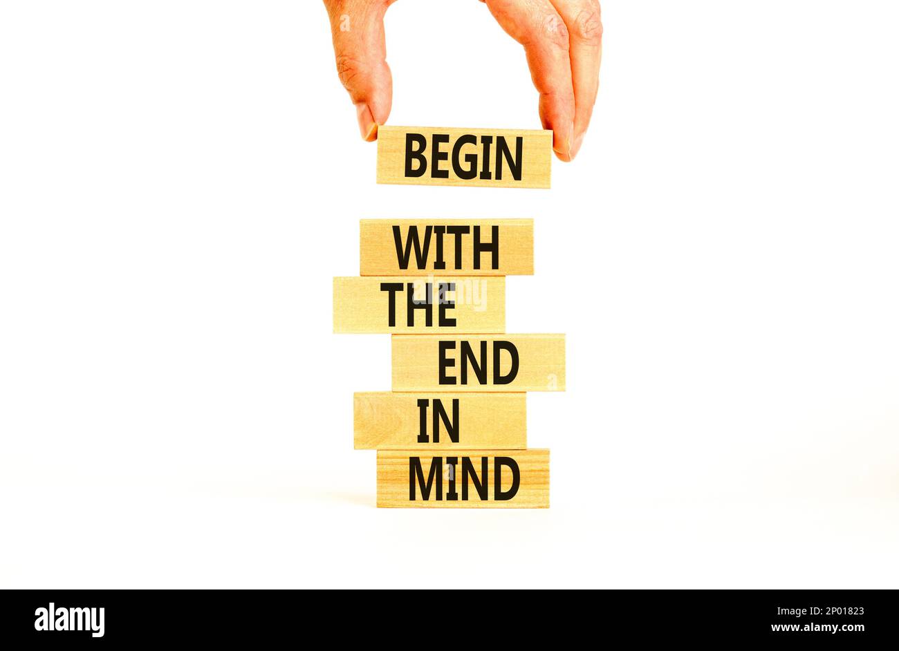 Begin in end of mind symbol. Concept words Begin with the end in mind on wooden blocks. Beautiful white table white background. Businessman hand. Busi Stock Photo
