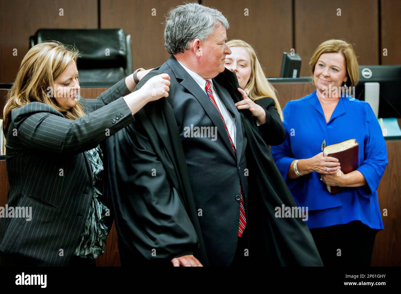 Timothy R. Coleman, center, gets help from his daughters Bowling Green