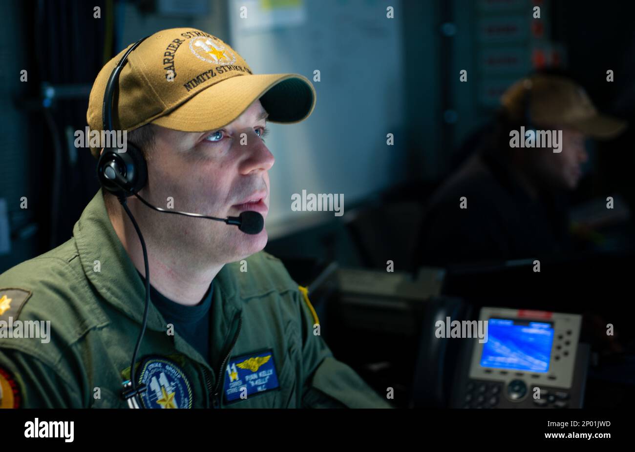 230216-N-WM182-1019 SOUTH CHINA SEA (Feb. 16, 2023) U.S. Navy Lt. Cmdr. Ryan Kelly, from Troy, N.Y., stands watch in the Tactical Flag Communication Center aboard the aircraft carrier USS Nimitz (CVN 68). Nimitz is in U.S. 7th Fleet conducting routine operations. 7th Fleet is the U.S. Navy's largest forward-deployed numbered fleet, and routinely interacts and operates with Allies and partners in preserving a free and open Indo-Pacific region. Stock Photo