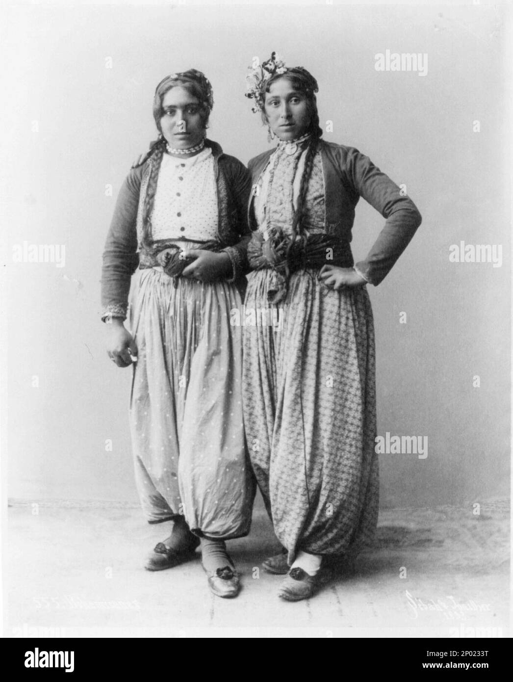 Two gypsy women standing, full lgth., Palestine. Palestine, Frank and Frances Carpenter Collection , Photograph by Sebah and Joaillier, No. 555, Caption card tracings: Photog. I.; Palestine; Gypsies; Ph. Ind; Geogr.; Shelf. Stock Photo