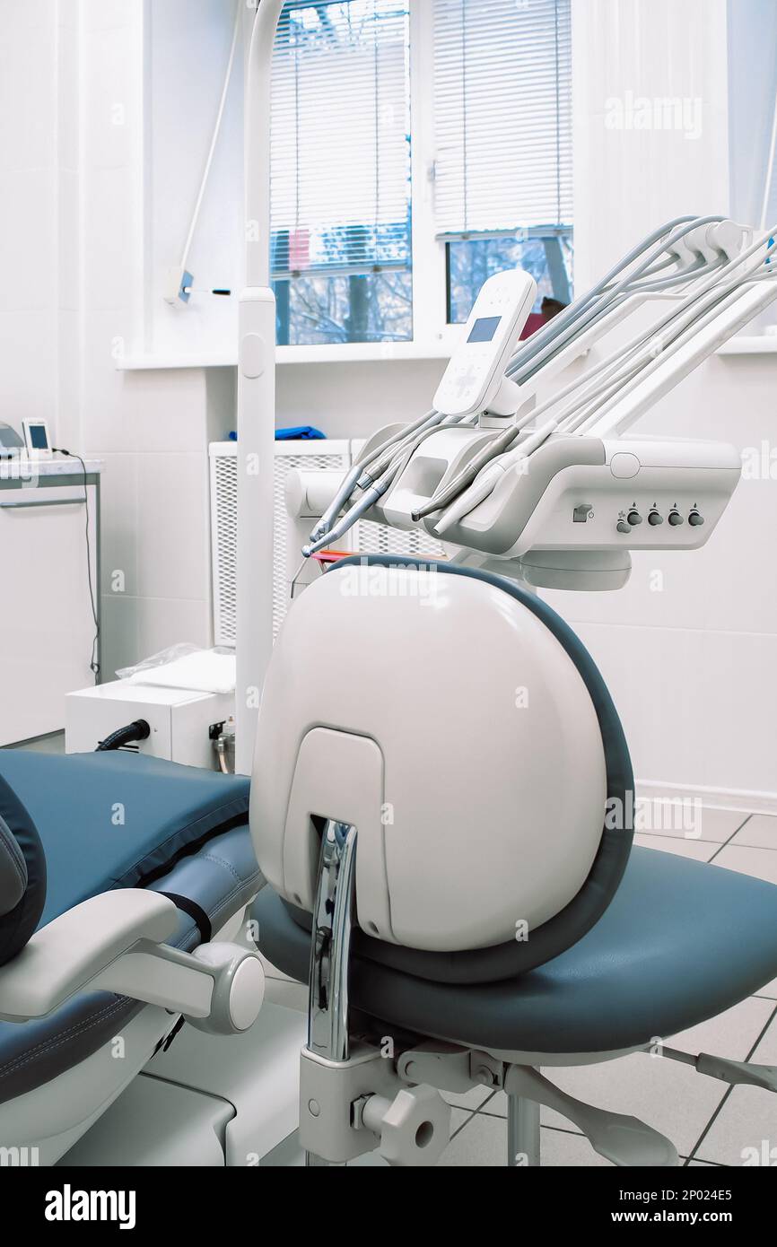 Close-up of modern dental equipment in dentistry clinic. Workplace and tools of dentists. Dental chair and surgical instruments for dental treatment. Stock Photo