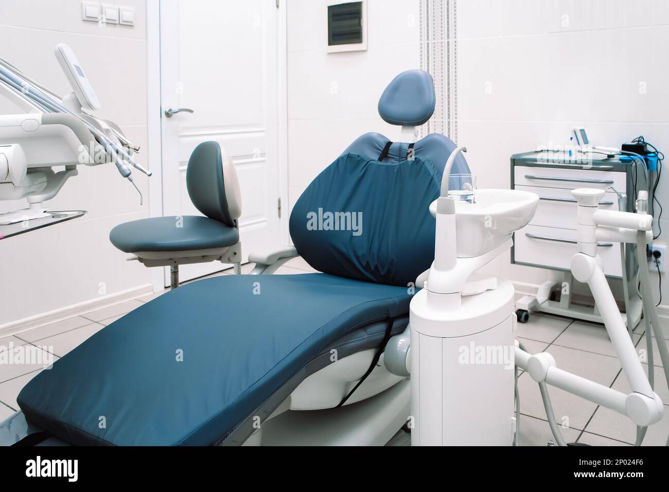 Close-up of modern dental equipment in dentistry clinic. Workplace and tools of dentists. Dental chair and surgical instruments for dental treatment. Stock Photo