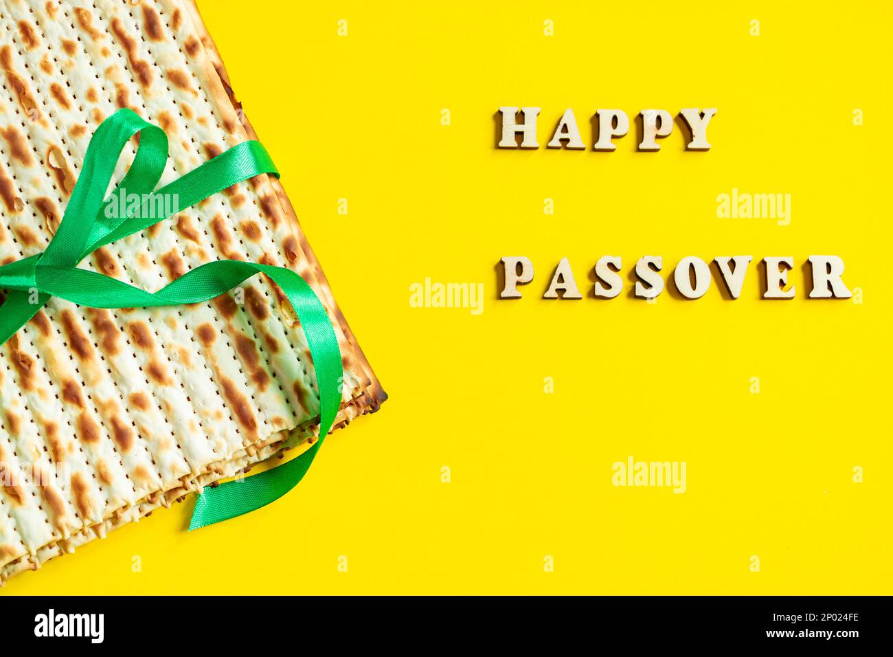 Traditional Jewish matzo on yellow background. Happy Passover. Pesach