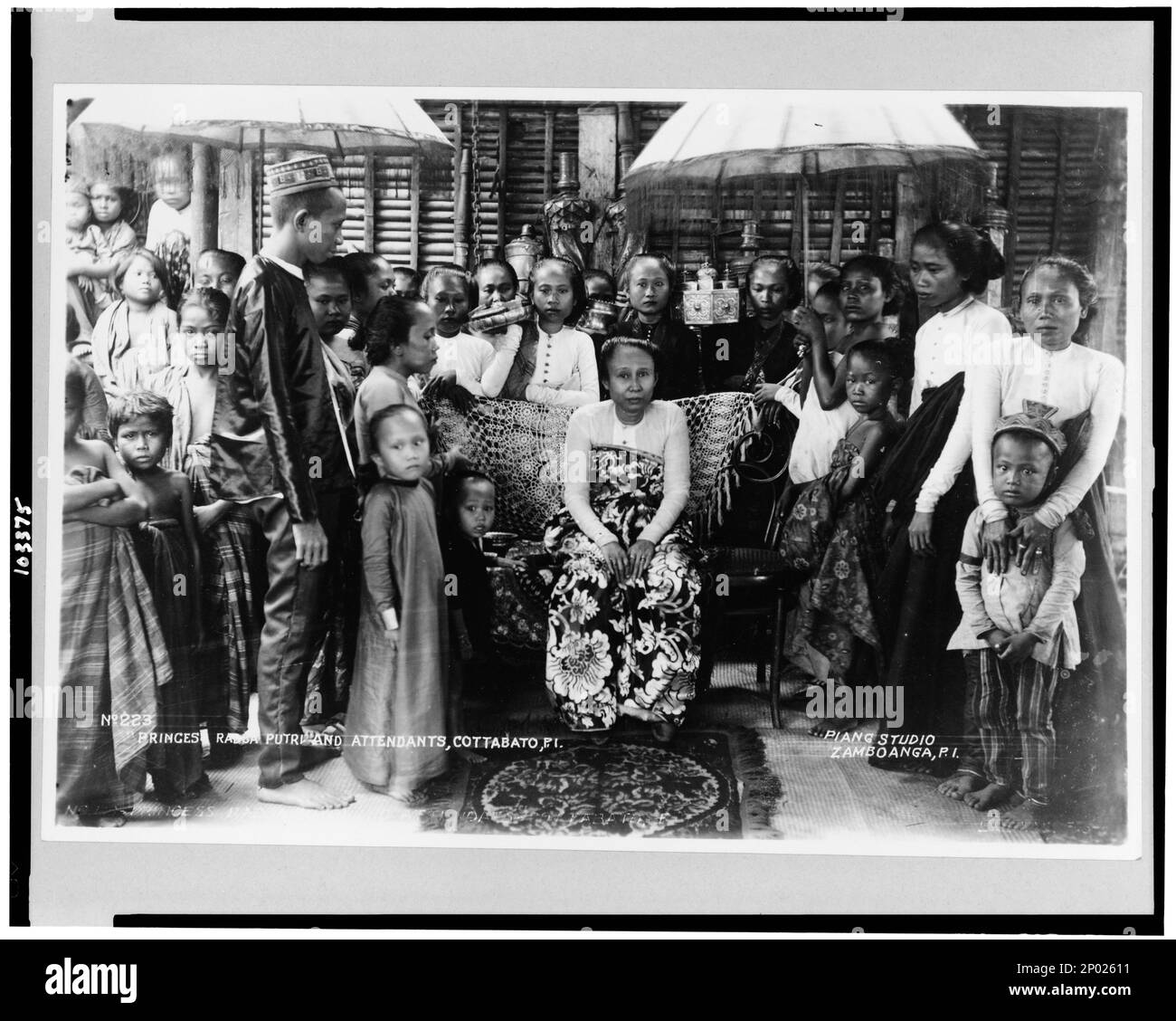 Princes sic Radcai.e. Radja? Putrie and attendants, Cottabatoi.e. Cotabato, P.I. / Piang Studio, Zamboanga, P.I. , Princes Radca Putrie and attendants, Cottabato, P.I.Princess Radja Putrie and attendants, Cotabato, P.I.. No. 223, Frank and Frances Carpenter Collection, Princesses,Philippines,Cotabato,1900-1930, Servants,Philippines,Cotabato,1900-1930. Stock Photo