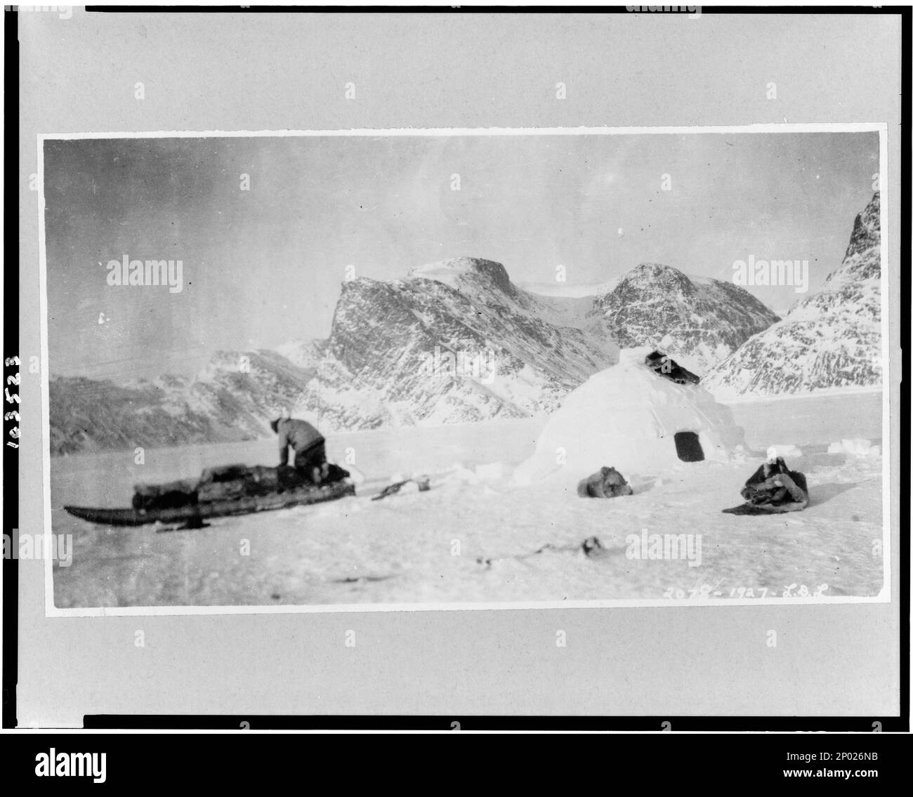 Eskimo building a snow house south of Cape St. David, Cumberland Gulf