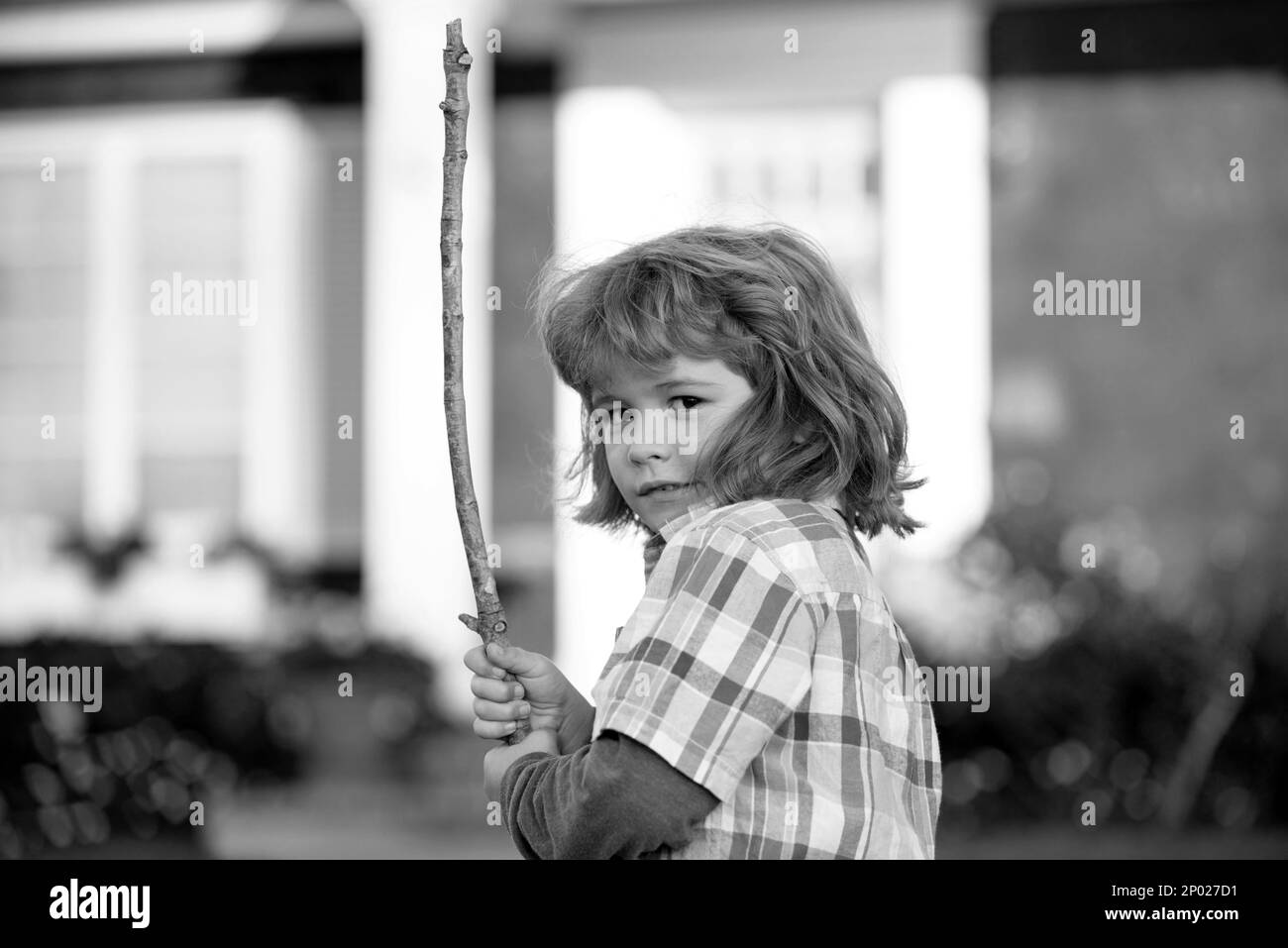 Negative child emotion. Kids aggression. Angry boy with stick. Kid