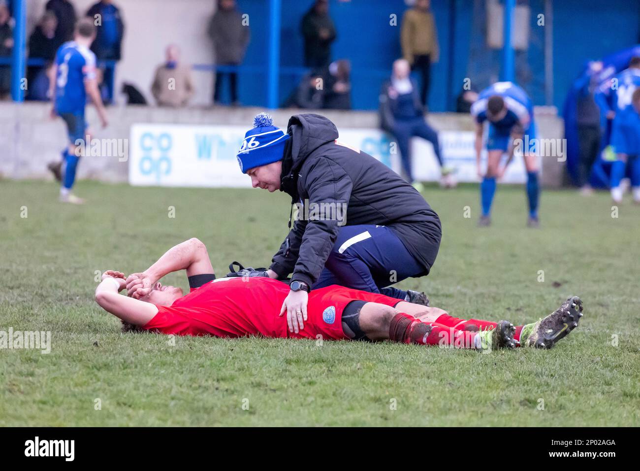 Whitby Town FC v Warrington Rylands 1906 FC – Dylan Vassallo twists his back in the NPL Premier League clash and is treated by the Physio Stock Photo