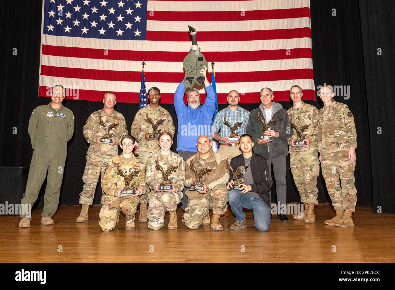 The fourth quarter awards winners stand together on stage at the Robert J. Dole Community Center ballroom, Jan. 27, 2023, at MCcConnell Air Force Base, Kansas. Quarterly award ceremonies are a way to recognize individuals and teams for their hard work and accomplishments throughout the previous three months. Stock Photo