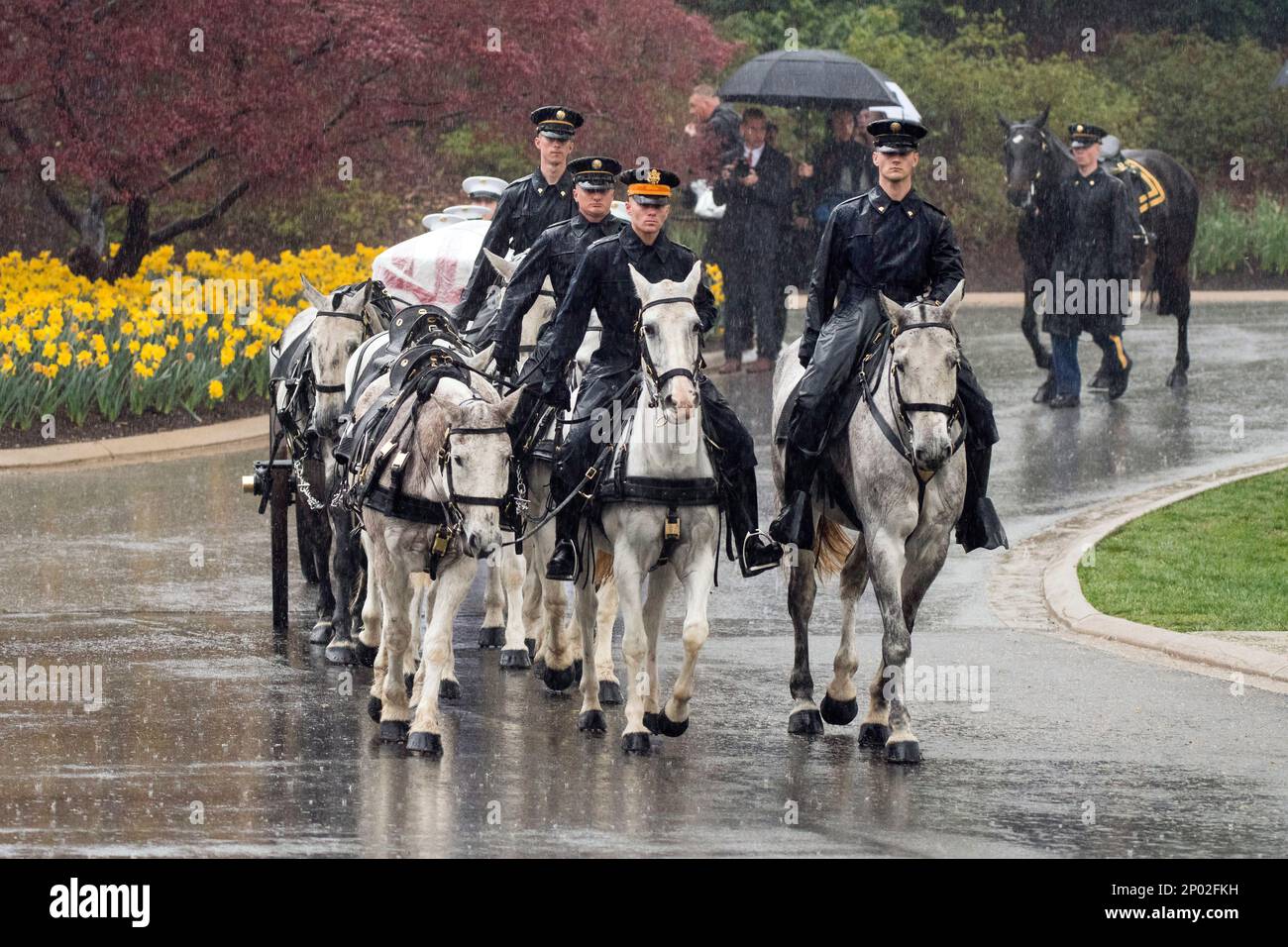 A horse drawn caisson carries former astronaut and Sen. John Glenn to